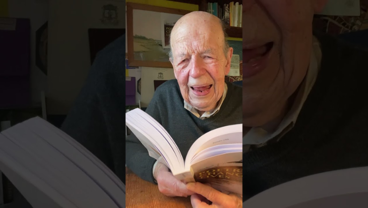 The screen is segmented into three vertical segments - in the middle segment, poet and writer Chris Burn reads from his book Poetry Changes Lives. In the segments wither side, the middle image is zoomed in on