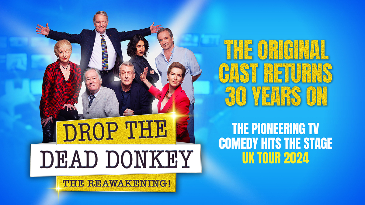 Promotional image for Drop the Dead Donkey: The Reawakening! featuring seven actors posed together. Text reads: “The original cast returns 30 years on. The pioneering TV comedy hits the stage. UK Tour 2024.” The background is blue with spotlight effects.