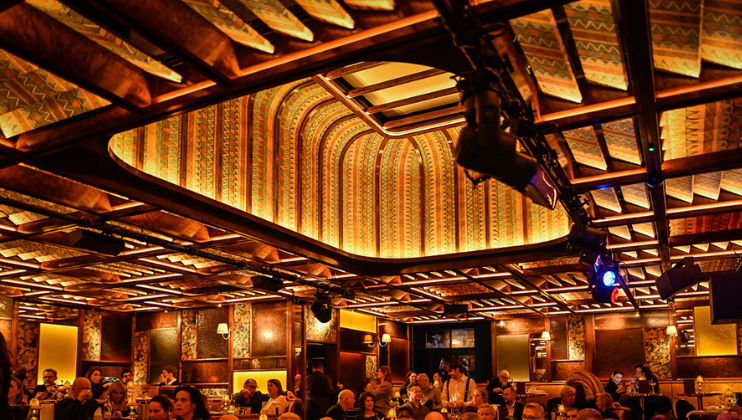 The impressive ceiling of the newly-refurbished Upstairs at Ronnie's, decorated in plush fabric with slanted vents and an upward cave at its centre