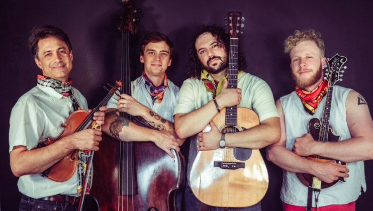 Big Love Car Wash hold their instruments to their chests against a dark background