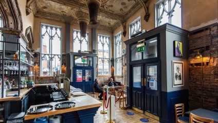 inside the pub, wooden floor and very ornate ceiling