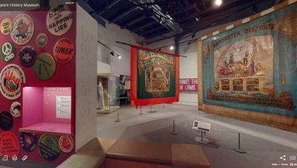 Inside one of the gallery spaces showing flags and large banners depicting signs of democracy