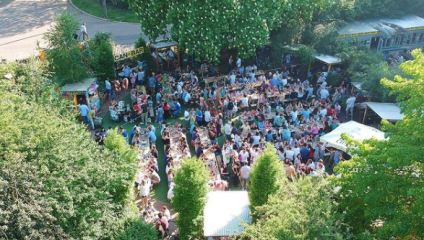 The People's Tavern back garden with lots of people on the grass in the sunshine