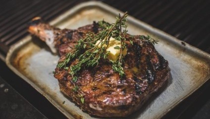 Large juicy steak with green garnish