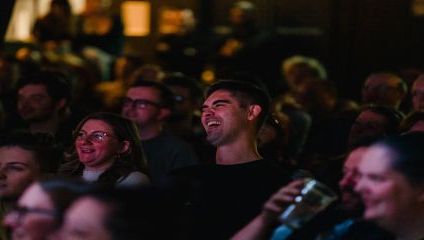 Audience members laughing at the Comedy acts