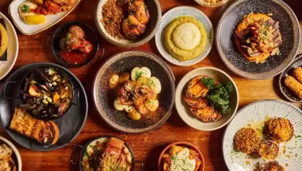 Lots of colourful small tapas food in bowls