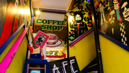 Colourful funky staircase up to Kenny’s Rock and Soul Cafe, featuring pop art of music legends on the wall.