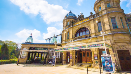 A low shot looking up at the elegant facade of Buxton Opera House