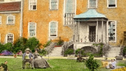 A vintage illustration of a large, two-story house with orange brick walls and several windows. The house features a small porch with steps leading down to a green lawn. Several people and a dog are scattered around the yard, engaged in various leisure activities.