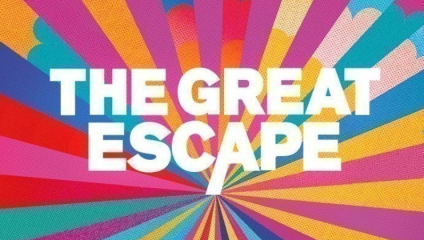 Multicolored rays in varying shades of pink, blue, yellow, and purple radiate outward from a central point. Bold white letters in the center read THE GREAT ESCAPE, with the vibrant background creating a dynamic and energetic effect.
