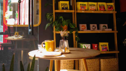 Sun streaming into Komodo Coffee’s chic interior, with coffee beans available to purchase.