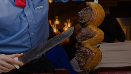Image of a chef carving a huge steak from the Brighton restaurant and all you can eat buffet Fogo de Chao
