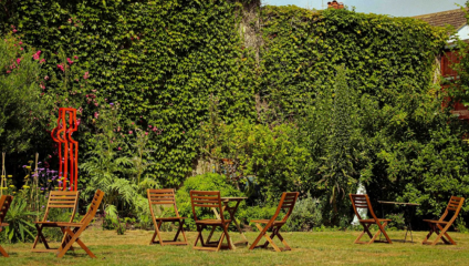 Outdoor seating and sculpture in the sunny Secret Garden in Kemptown.
