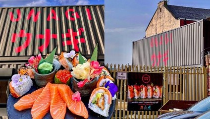 Platter of sushi on a plate and the Unagi restaurant the background with Japanese red writing on it