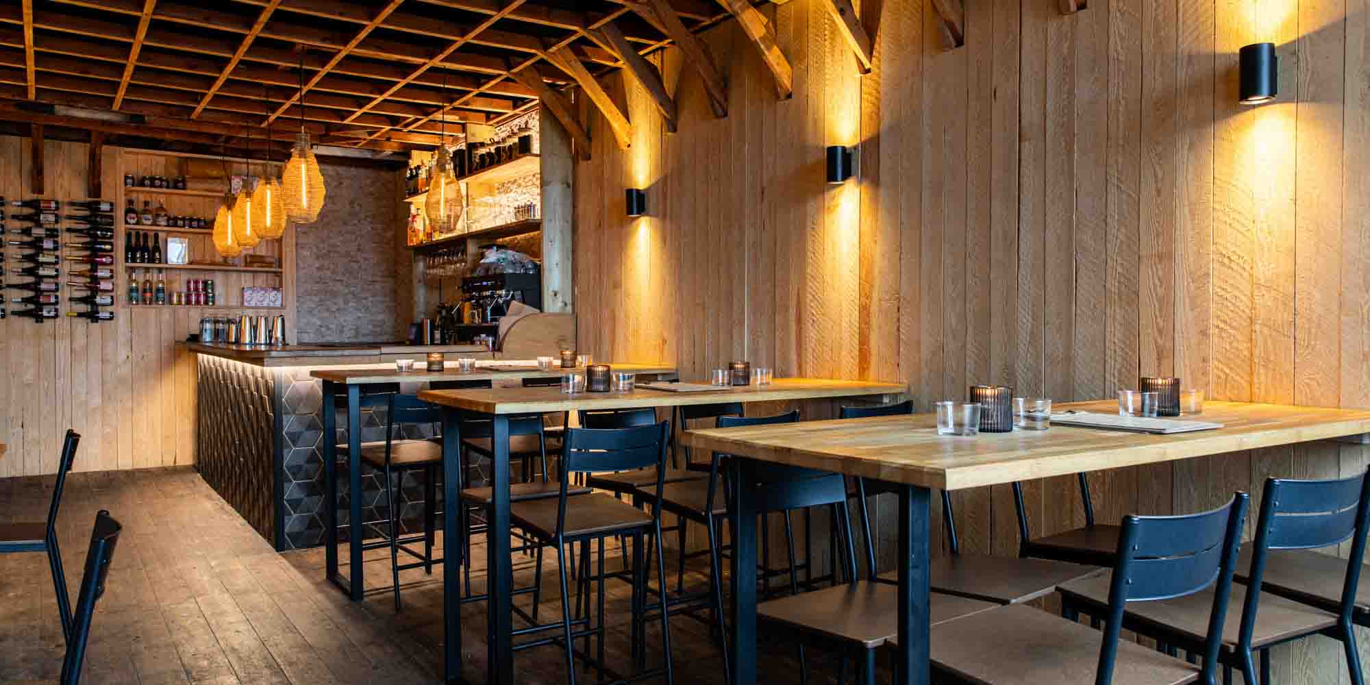 Apiary's chic wooden interior, featuring splashes of honeycomb pattern tile.