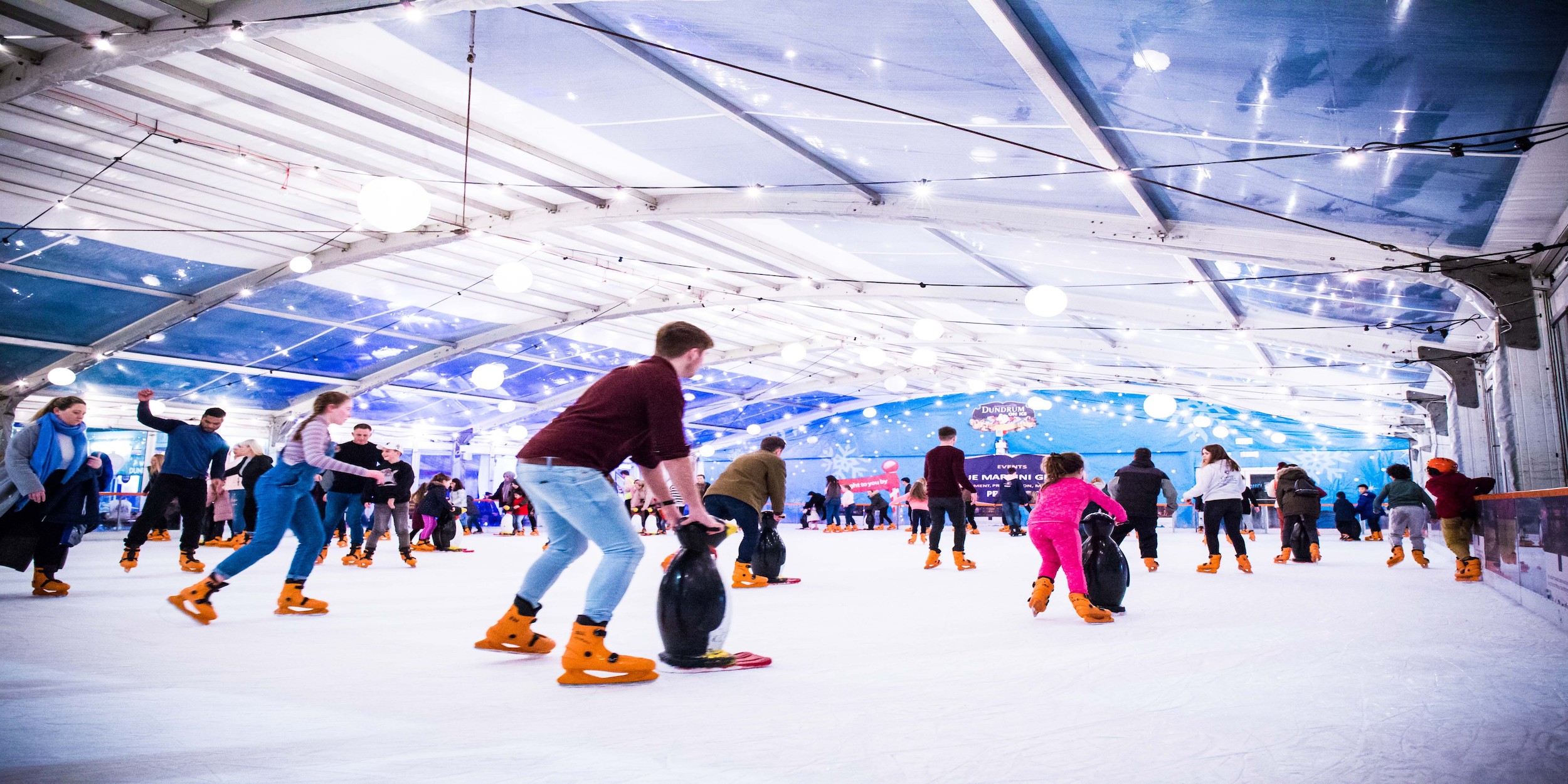 An ice rink being enjoyed by the public.