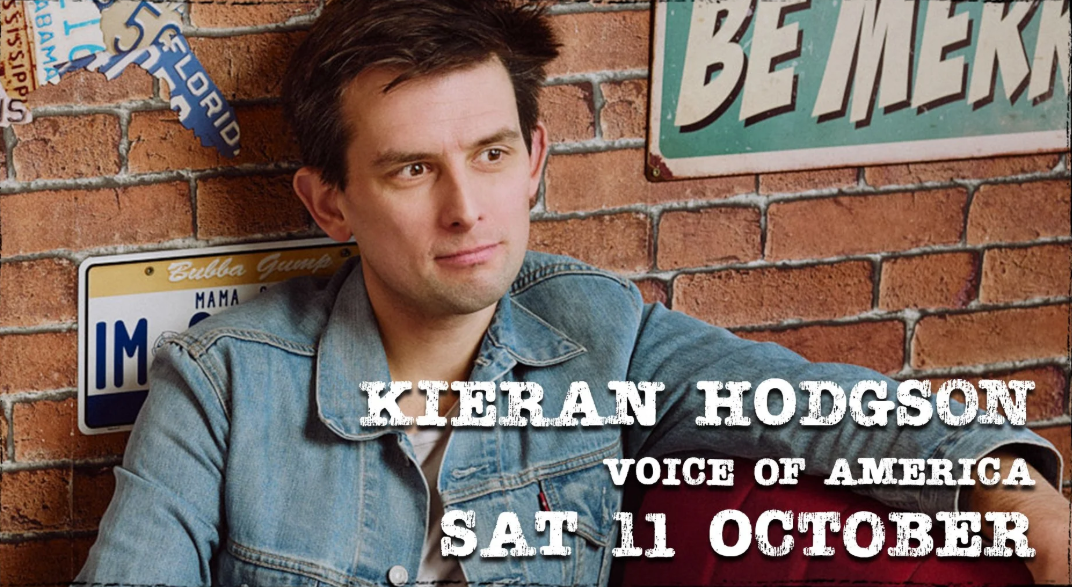 Kieran Hodgson looking incredulous in front of an American diner style wall.