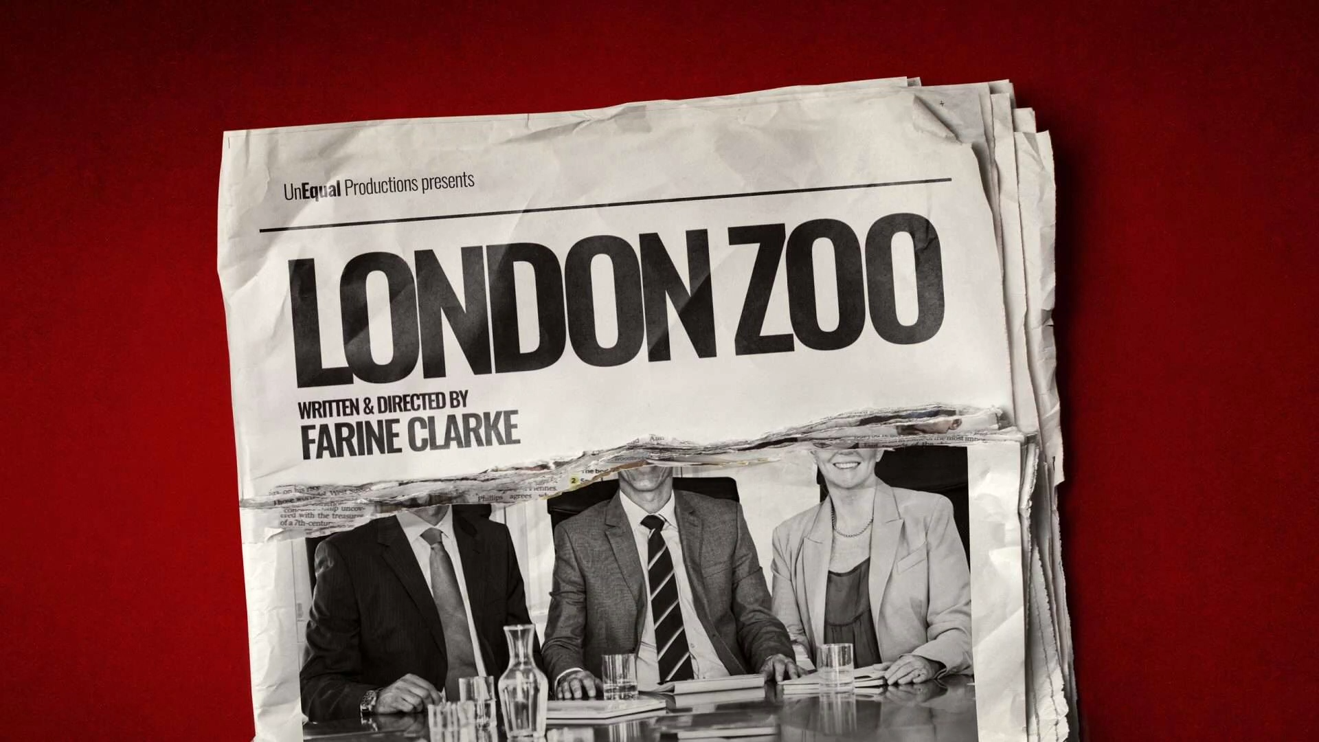 A wrinkled newspaper with the headline LONDON ZOO, written and directed by Farine Clarke, is shown on a red background. Below the headline is a partial black-and-white photo of three people in business attire seated at a table. The image is cropped to hide their faces.