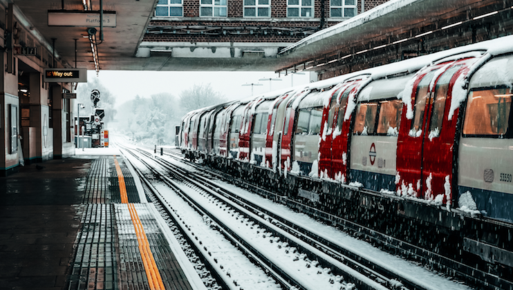 London underground train in train station covered in snow