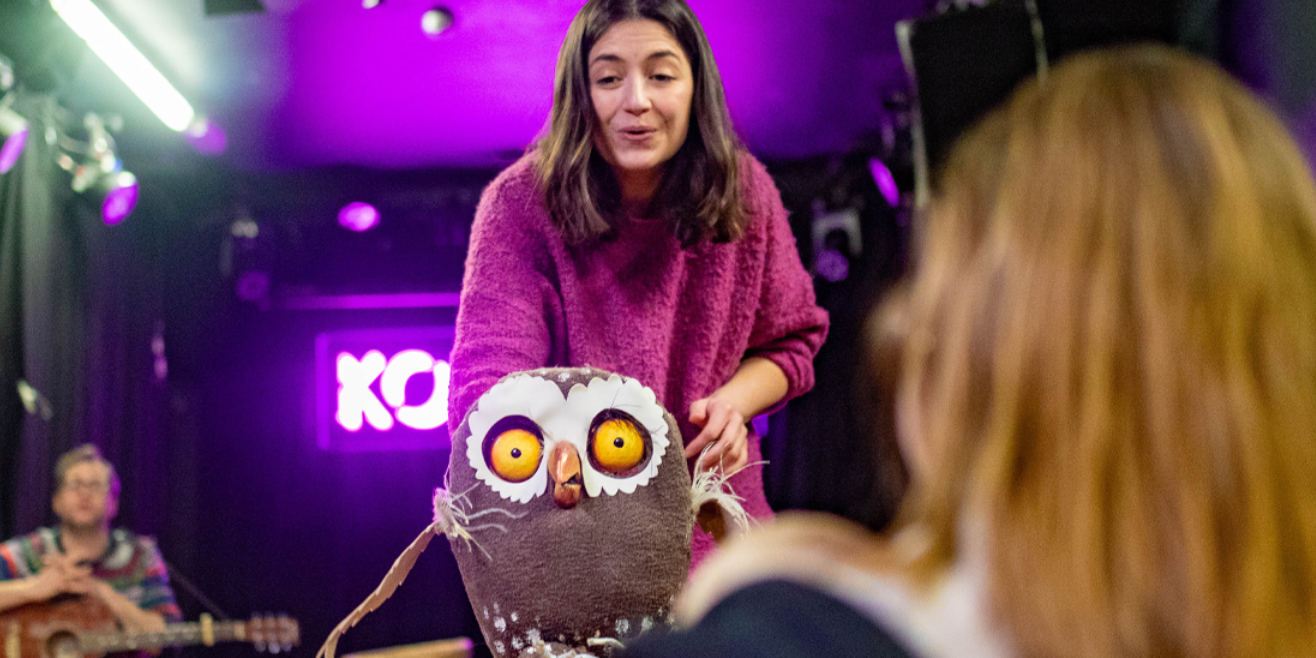 Bubbly Story Magic children's performer at neon-lit Komedia venue.