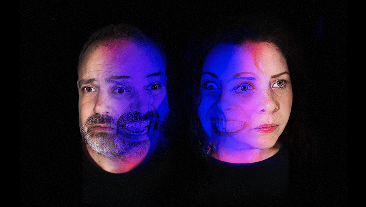 A split-image portrait of two people with both realistic and artistic interpretations of their faces. The left person has a blue overlay and partial transparent angry face, while the right person has similar blue lighting and overlaying transparent face with dramatic expression.