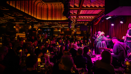Bathed in purple light, jazz musicians perform to the crowd at the newly-refurbished, 140-seat Upstairs at Ronnie's
