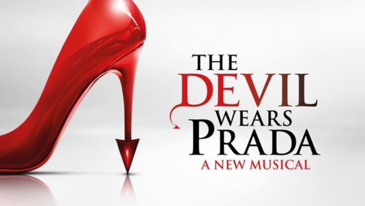 Image of a red stiletto heel piercing the ground with the text The Devil Wears Prada: A New Musical written beside it. The word Devil is stylized with a red D having a devilish tail. The background is gradient white and gray.