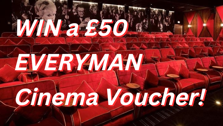A red velvet-seated cinema theater is shown with bright lights along the walls. The image text reads WIN a £50 EVERYMAN Cinema Voucher! in bold white and red letters. The cinema is empty and features small wooden tables attached to each seat.