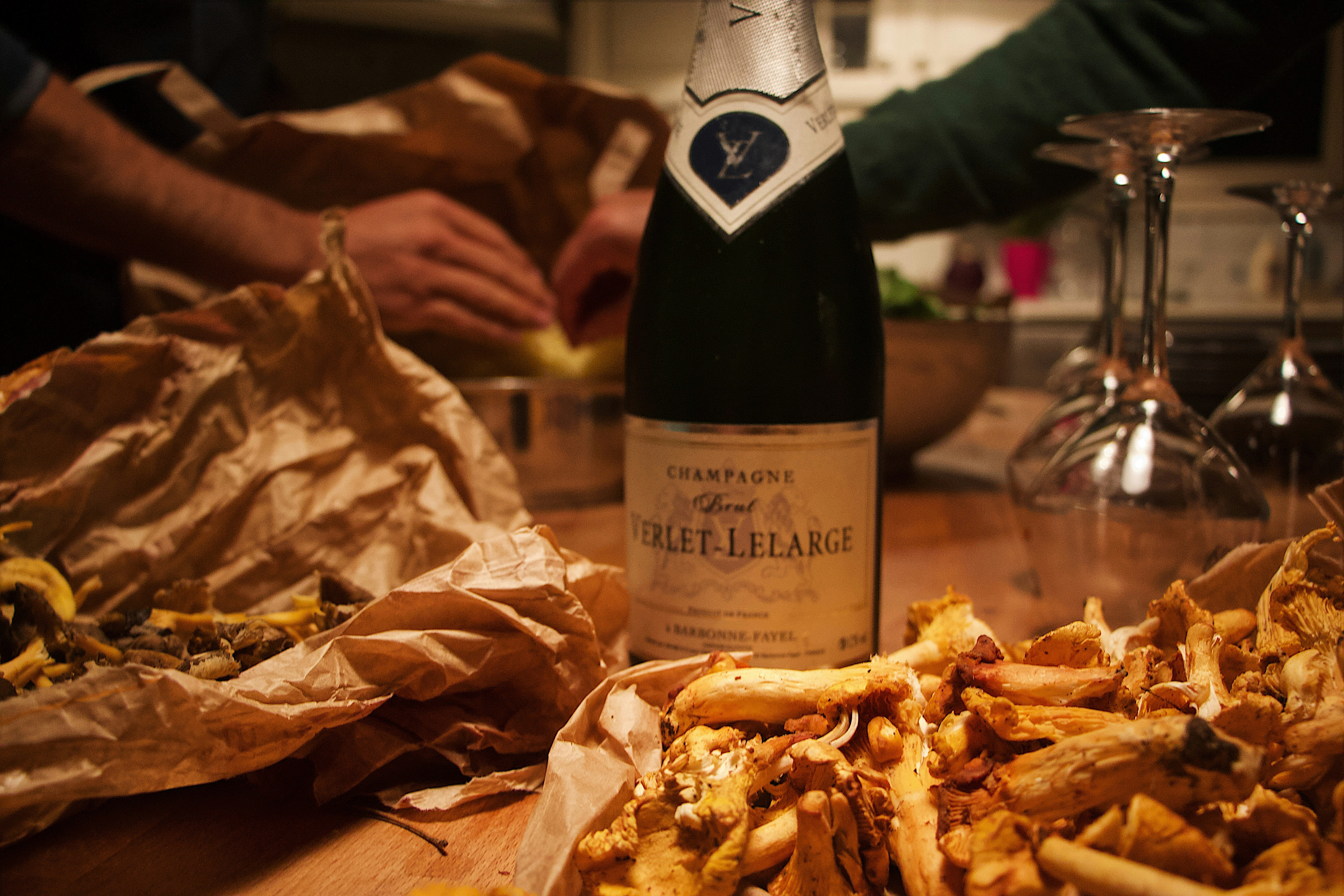 wine bottle in the middle of a wooden table with chips