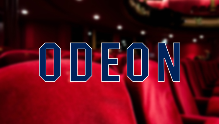 A blurred image of a theater interior with vibrant red seats, featuring the word ODEON in bold blue letters at the center.