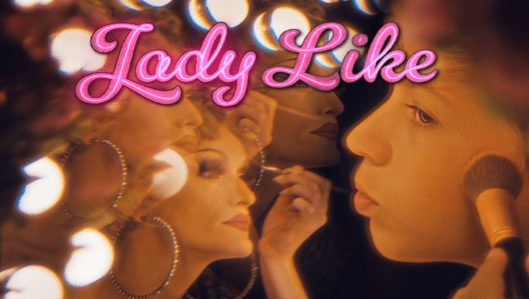 Three images of a person applying makeup are overlaid against a backdrop of glowing lights. The central image is a close-up of the subject applying foundation with a brush. The text Lady Like in pink cursive font is prominently featured at the top of the image.